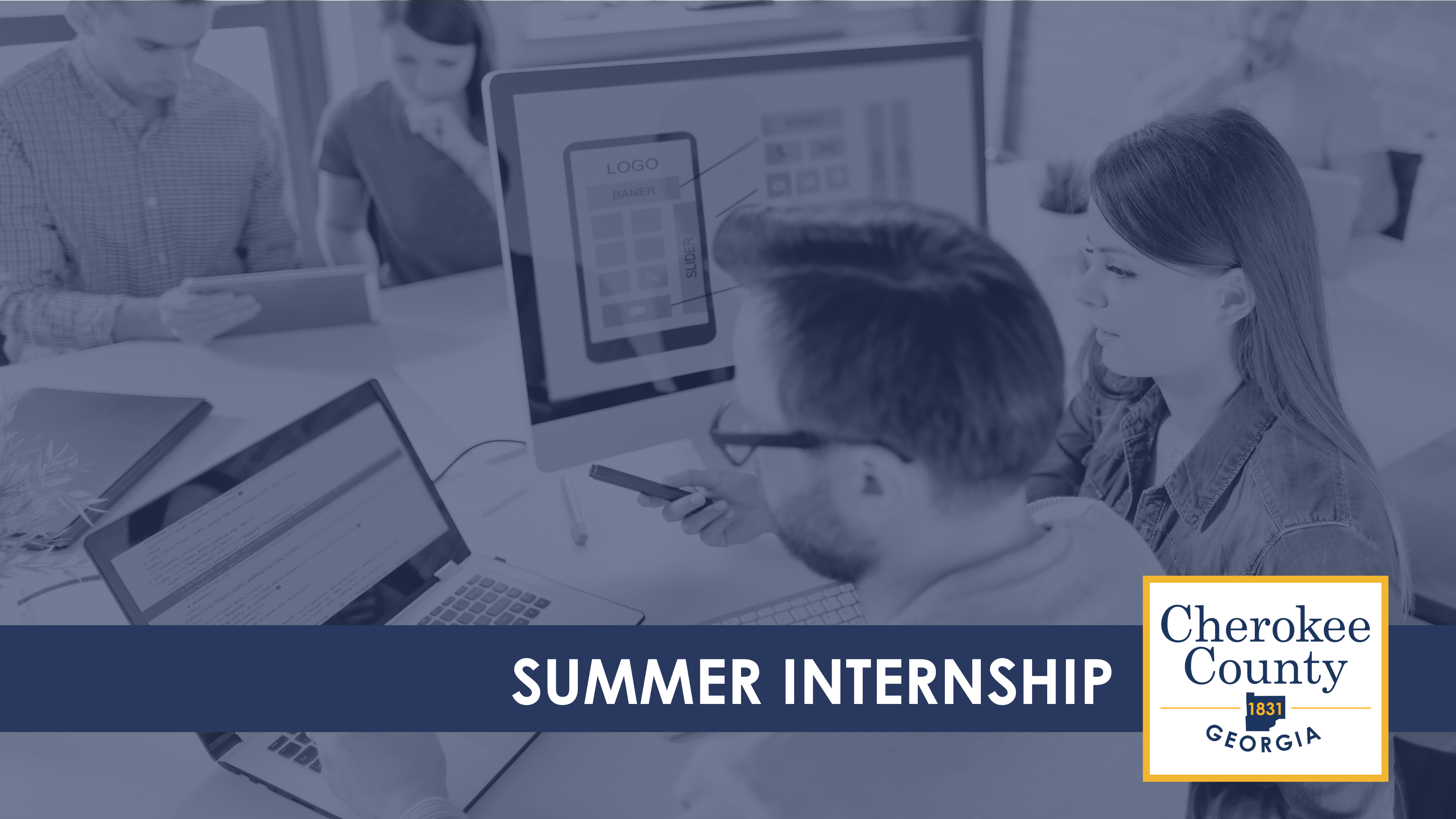 Stock image of two people looking at a computer with text overlay that reads Summer Internship